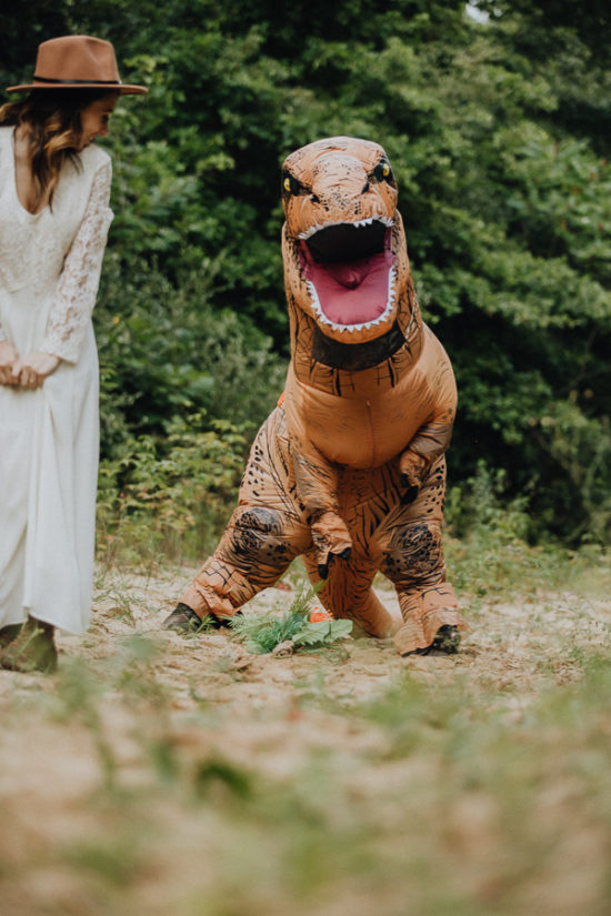 a trex tries to pick up a bouquet
