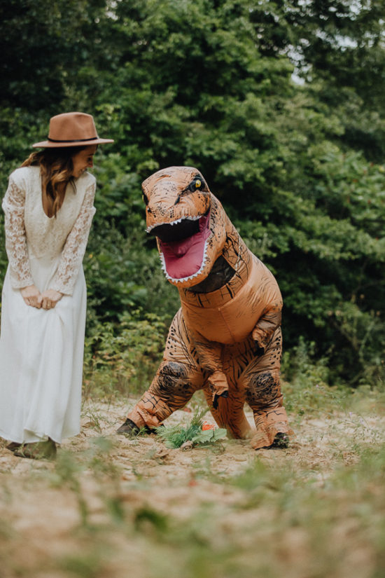 a trex tries to pick up a bouquet